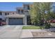 Beautiful two-story home featuring a two-car garage, manicured lawn, and mature landscaping at 18811 E Pelican Ct, Queen Creek, AZ 85142