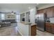 Open kitchen with a granite island, stainless steel appliances and adjacent living area at 18811 E Pelican Ct, Queen Creek, AZ 85142