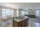 Open-concept kitchen with island and adjacent living and dining spaces, ample natural light at 18811 E Pelican Ct, Queen Creek, AZ 85142