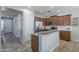 Modern kitchen featuring stainless steel appliances, granite countertops, and brown cabinetry at 18811 E Pelican Ct, Queen Creek, AZ 85142