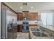Updated kitchen featuring granite countertops, stainless steel appliances, and tile backsplash at 18811 E Pelican Ct, Queen Creek, AZ 85142