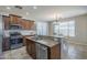 Well-equipped kitchen with granite countertops, stainless steel appliances, and a cozy dining area at 18811 E Pelican Ct, Queen Creek, AZ 85142