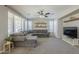 Cozy living room with plush gray sectional sofa, carpet, and neutral color palette at 18811 E Pelican Ct, Queen Creek, AZ 85142