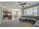 Open-concept living room showcasing a gray sectional sofa, with kitchen and dining views at 18811 E Pelican Ct, Queen Creek, AZ 85142