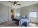 Spacious main bedroom with a ceiling fan, carpet flooring, natural light and attached bathroom at 18811 E Pelican Ct, Queen Creek, AZ 85142