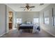 Spacious main bedroom with a ceiling fan, carpet flooring, natural light and attached bathroom at 18811 E Pelican Ct, Queen Creek, AZ 85142