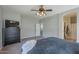 Spacious main bedroom with a ceiling fan, carpet flooring, and large dresser for storage at 18811 E Pelican Ct, Queen Creek, AZ 85142