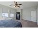 Spacious main bedroom with a ceiling fan, carpet flooring, natural light and large dresser at 18811 E Pelican Ct, Queen Creek, AZ 85142