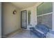 Cozy outdoor patio with wrought iron seating, a charming sconce, and natural light from nearby windows at 18811 E Pelican Ct, Queen Creek, AZ 85142