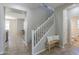 Inviting entryway with a carpeted staircase and neutral decor creates a warm and welcoming ambiance at 18811 E Pelican Ct, Queen Creek, AZ 85142