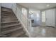 Carpeted staircase with white railing leading to the upper level of the home with neutral decor at 18811 E Pelican Ct, Queen Creek, AZ 85142