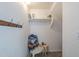 Storage space featuring a rack of hanging hooks, a chair, and a shelf for decorative items at 18811 E Pelican Ct, Queen Creek, AZ 85142