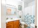 Bright bathroom featuring a wood vanity, framed mirror, and a floral curtain at 19403 E Arrowhead Trl, Queen Creek, AZ 85142