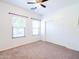 Spacious bedroom features neutral carpet, ceiling fan, and double-door closet at 19403 E Arrowhead Trl, Queen Creek, AZ 85142