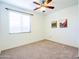 Bright bedroom with neutral carpet, ceiling fan, and window with blinds allowing natural light at 19403 E Arrowhead Trl, Queen Creek, AZ 85142