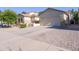 Inviting home exterior with manicured lawn and a spacious driveway leading to a two-car garage at 19403 E Arrowhead Trl, Queen Creek, AZ 85142