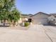 Charming single-story home featuring a two-car garage, low maintenance landscaping, and a inviting front entrance at 19403 E Arrowhead Trl, Queen Creek, AZ 85142