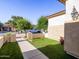 Attractive front yard featuring artificial turf, well-maintained landscaping, and a charming walkway to the entrance at 19403 E Arrowhead Trl, Queen Creek, AZ 85142