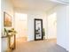 Open hallway featuring neutral paint, carpet, decorative accents, and a view of multiple rooms for smooth transitions at 19403 E Arrowhead Trl, Queen Creek, AZ 85142