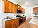 Well-appointed kitchen featuring warm wood cabinets, stainless appliances, and granite countertops at 19403 E Arrowhead Trl, Queen Creek, AZ 85142