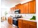 Kitchen featuring wood cabinets, stainless appliances, and tiled floors at 19403 E Arrowhead Trl, Queen Creek, AZ 85142