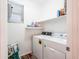 Laundry room with washer, dryer, shelving and a window for natural light at 19403 E Arrowhead Trl, Queen Creek, AZ 85142