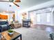 Open-concept living room with fireplace and seamless flow to kitchen and entry at 19403 E Arrowhead Trl, Queen Creek, AZ 85142