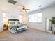 Serene main bedroom with plush carpet, a ceiling fan, a king-size bed, and ample natural light at 19403 E Arrowhead Trl, Queen Creek, AZ 85142