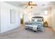 Large main bedroom with a bench at the end of the bed and an ensuite bathroom at 19403 E Arrowhead Trl, Queen Creek, AZ 85142