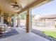 Covered patio with ceiling fan and patio seating that has a view of the sparkling pool at 19403 E Arrowhead Trl, Queen Creek, AZ 85142