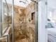 Walk in shower with upgraded stone surround, niche storage and upgraded shower head fixture at 19403 E Arrowhead Trl, Queen Creek, AZ 85142
