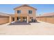Rear view of a two-story home with a covered patio and a large, enclosed backyard at 22196 W Tonto St, Buckeye, AZ 85326