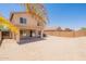 Expansive backyard featuring a covered patio, block fence and ample space for outdoor activities at 22196 W Tonto St, Buckeye, AZ 85326
