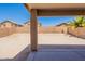 A spacious backyard with a covered patio, gravel landscaping, and privacy fence at 22196 W Tonto St, Buckeye, AZ 85326
