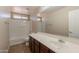 A spacious bathroom with a vanity, mirror, and a combined shower and bathtub at 22196 W Tonto St, Buckeye, AZ 85326