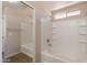 Bright bathroom featuring a large tub, shower, and neutral tile surround at 22196 W Tonto St, Buckeye, AZ 85326