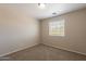 A cozy bedroom with carpet flooring, neutral walls, and a window offering natural light at 22196 W Tonto St, Buckeye, AZ 85326