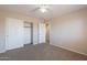 A bedroom showcasing carpet flooring, a ceiling fan, and a closet offering storage solutions at 22196 W Tonto St, Buckeye, AZ 85326