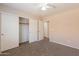 A bedroom with a ceiling fan, closet, and neutral walls at 22196 W Tonto St, Buckeye, AZ 85326