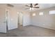 Carpeted bedroom featuring a ceiling fan and an open doorway to the bathroom at 22196 W Tonto St, Buckeye, AZ 85326