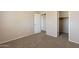Bedroom featuring neutral walls, carpet flooring, doors, and closet for storage solutions at 22196 W Tonto St, Buckeye, AZ 85326