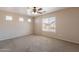 Cozy bedroom with neutral walls, plush carpet, and a ceiling fan for added comfort at 22196 W Tonto St, Buckeye, AZ 85326