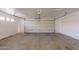 A spacious two-car garage with white walls, concrete flooring, and an automatic door at 22196 W Tonto St, Buckeye, AZ 85326