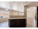 A kitchen island with a sink and views of the living room and backyard at 22196 W Tonto St, Buckeye, AZ 85326
