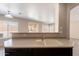 A sink on the kitchen island with views of the living room and backyard at 22196 W Tonto St, Buckeye, AZ 85326
