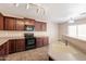 A kitchen featuring dark wood cabinets, stainless steel appliances, and a sink at 22196 W Tonto St, Buckeye, AZ 85326