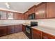 A kitchen featuring dark wood cabinets, tile floors, and modern appliances at 22196 W Tonto St, Buckeye, AZ 85326