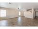 Expansive living room filled with natural light, featuring tile floors and a staircase leading to the upper level at 22196 W Tonto St, Buckeye, AZ 85326