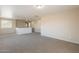 Open concept living area showcasing neutral paint, plush carpeting, and a view of the landing at 22196 W Tonto St, Buckeye, AZ 85326
