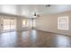 Spacious living room boasts tile flooring, abundant light from large windows, and a sliding glass door to the outside at 22196 W Tonto St, Buckeye, AZ 85326